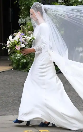 The designer adjusted the bride's veil and train before she made her grand entrance