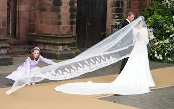 The designer adjusted the bride's veil and train before she made her grand entrance