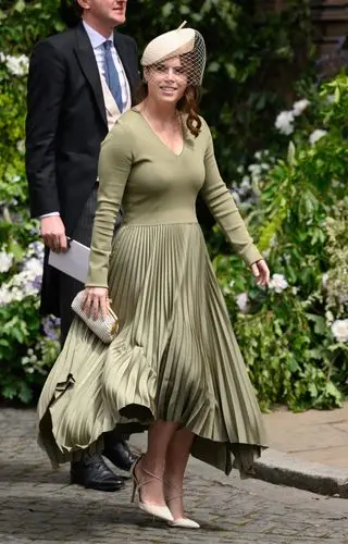 Princess Eugenie wears a green pleated dress by Joseph with Meghan Markle's Aquazurra pumps to attend the wedding of Olivia Henson and the Duke of Westminster