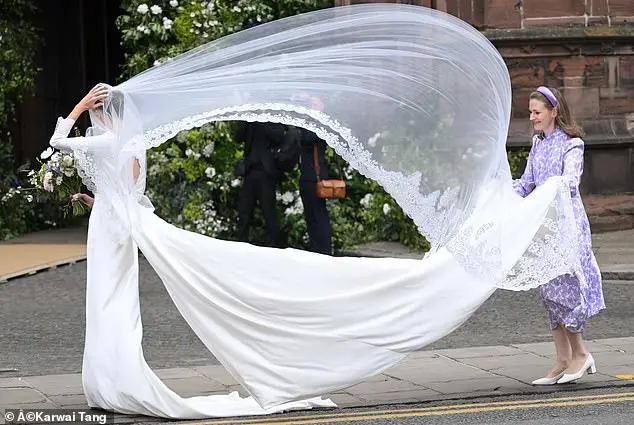 The bride's bespoke lace veil, and two metre-long detachable train, prompted gasps from the assembled crowds as they blew in the wind (pictured L-R: Olivia Henson; Emma Victoria Payne)