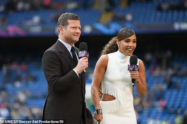 The dress also featured a fringe trim and she added extra height to her frame with a pair of stylish heels (pictured with Dermot O'Leary)