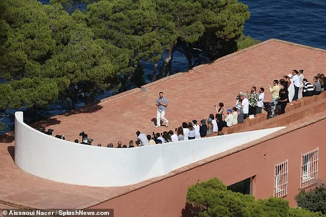 Guests gathered on the top of a building in front of the Mediterranean on Monday