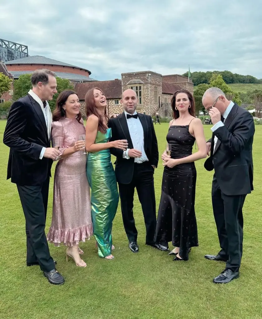 group of friends standing on lawn in smart clothes