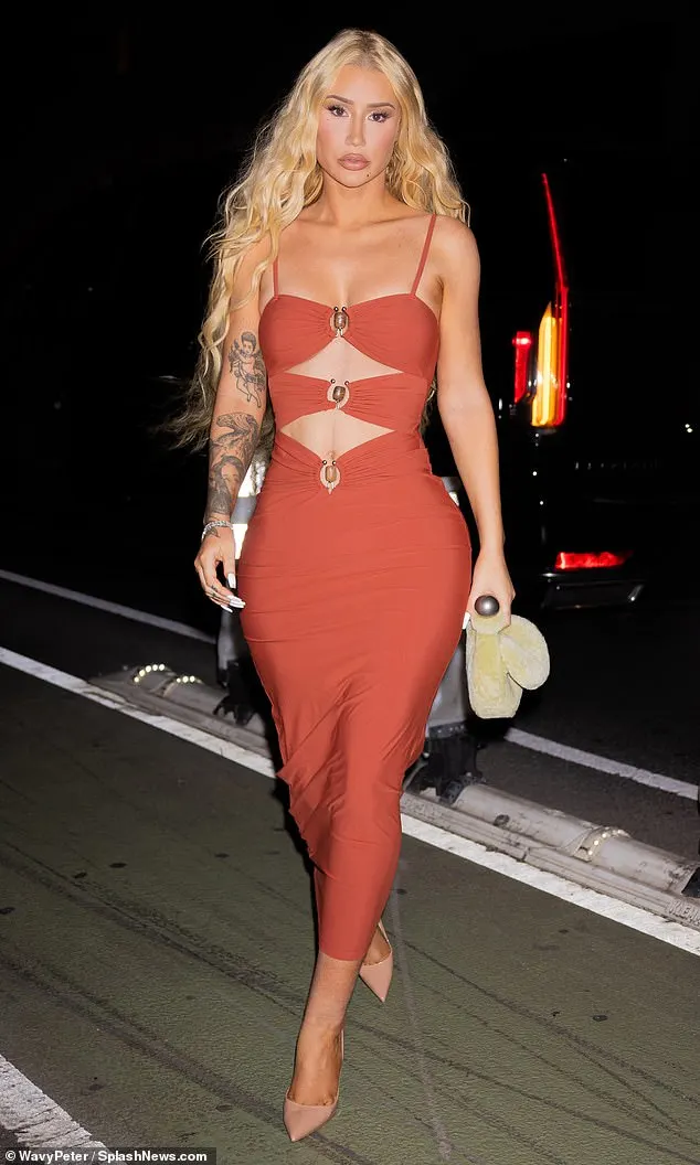 Iggy Azalea sent temperatures soaring in a burnt orange midi dress as she stepped out in New York City on Wednesday