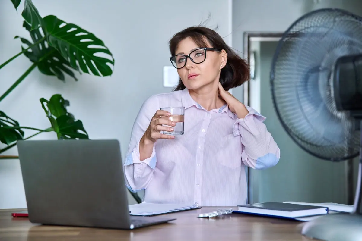 Woman Overheating Office Desk Fan