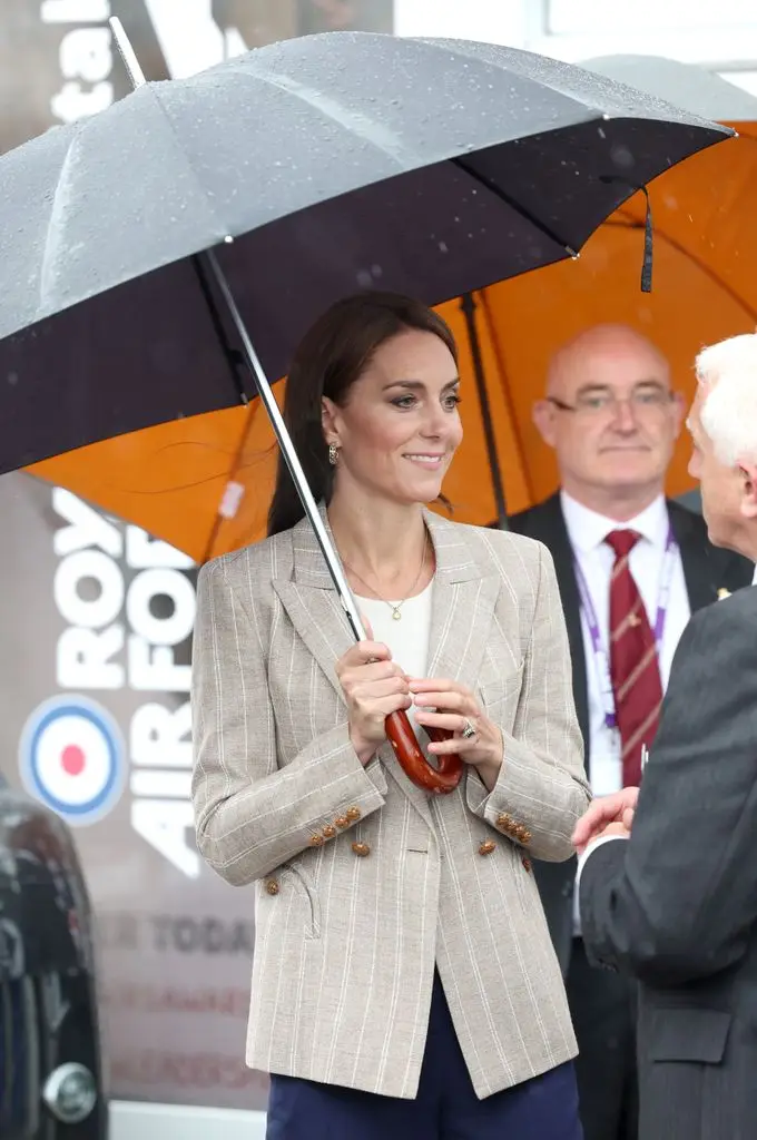 Princess Kate in striped blazer holding umbrella