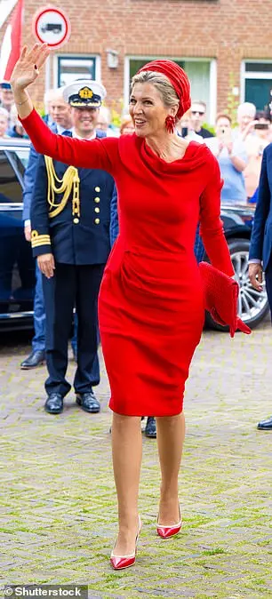 The mother-of-three looked rosy in red as she arrived in the small Dutch town wearing a knee length dress with long sleeves and a ruffled cow neck. She waved enthusiastically at smiling crowds