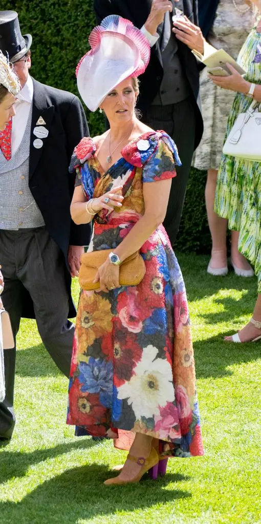 sophie in bold floral dress with mustard bag and big hat