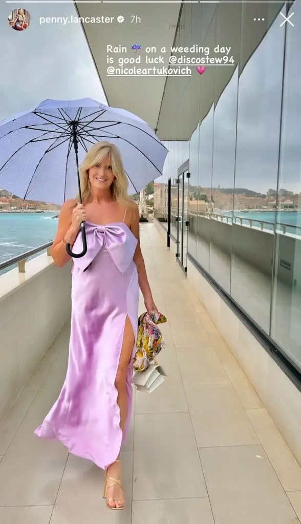 Penny lancaster in lilac dress holding umbrella