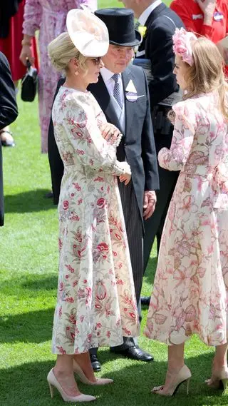 Zara Tindall wearing a pink floral dress attends day two of Royal Ascot 2024 and talks with Princess Beatrice