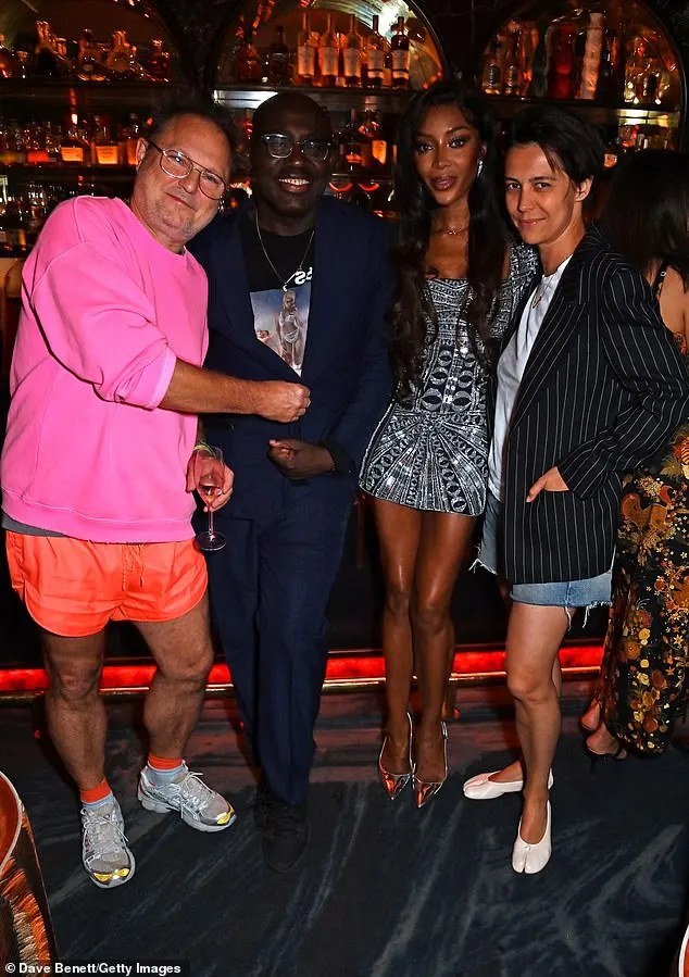 Naomi added height to her frame with a pair of silver heels and accessorised with an infinity symbol necklace (L-R Juergen Teller, Edward, Naomi and Dovile Drizyte)