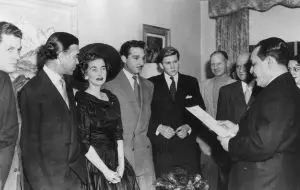 Dominican diplomat and socialite Porfirio Rubirosa (1909 - 1965) (second left) stands next to American socialite and Woolworth's heiress Barbara Hutton (1912 - 1979) during their wedding ceremony, Paris, France, December 30, 1953. Hutton's teenage son Lance Haugwitz-Reventlow (1936 - 1972) (center) is among the wedding party. The marriage lasted a little over 50 days. (Photo by Keystone/Getty Images)