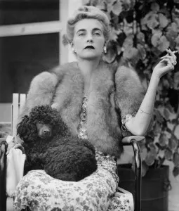 Countess Haugwitz-Reventlow (Barbara Hutton) is seated with a poodle in her lap as she watches a tennis match at Palm Beach, Florida, January 18, 1940.