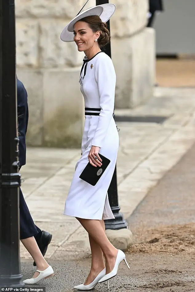 At Trooping the Colour, Princess Kate arrived wearing a white Jenny Packham dress with black trim and ribbon embellishment on the neckline