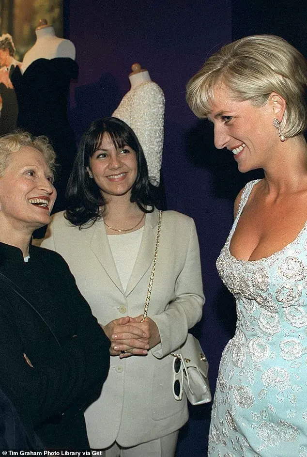 Princess Diana wearing a pale blue Catherine Walker dress whilst chatting to the designer of the 'Revenge' dress, Christina Stambolian in 1997