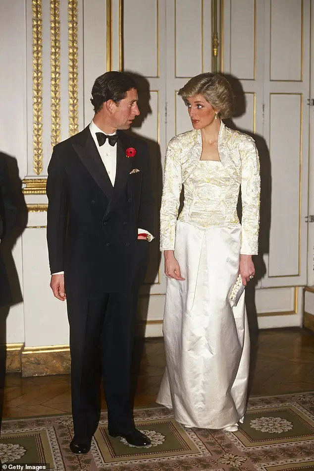 A tense Princess Diana in a cream silk gown with Prince Charles during a visit to Paris in 1988