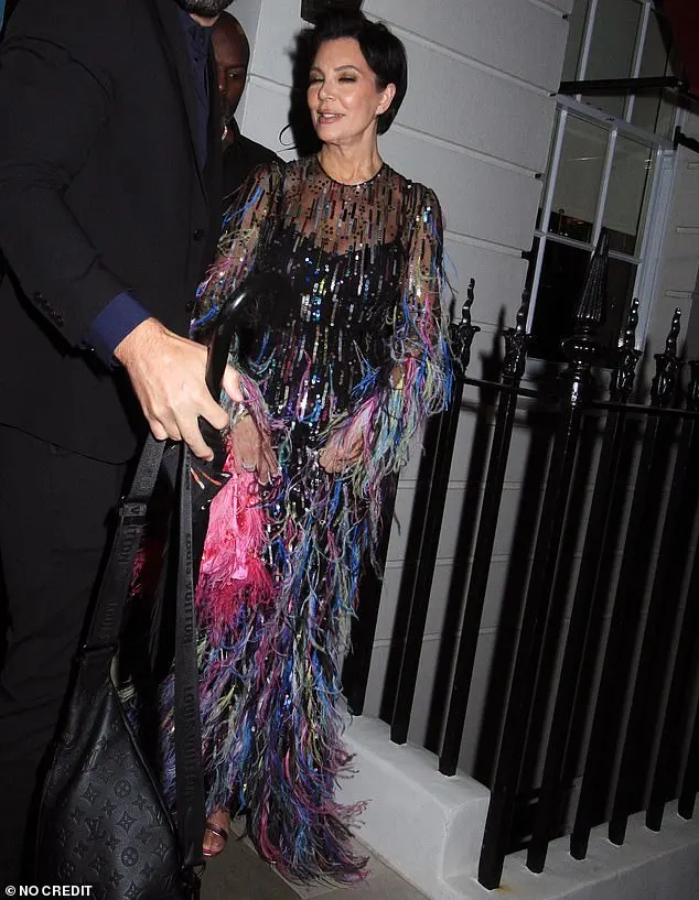 The Kardashian-Jenner matriarch wore a form-fitting plain black dress underneath the sheer long-sleeved creation