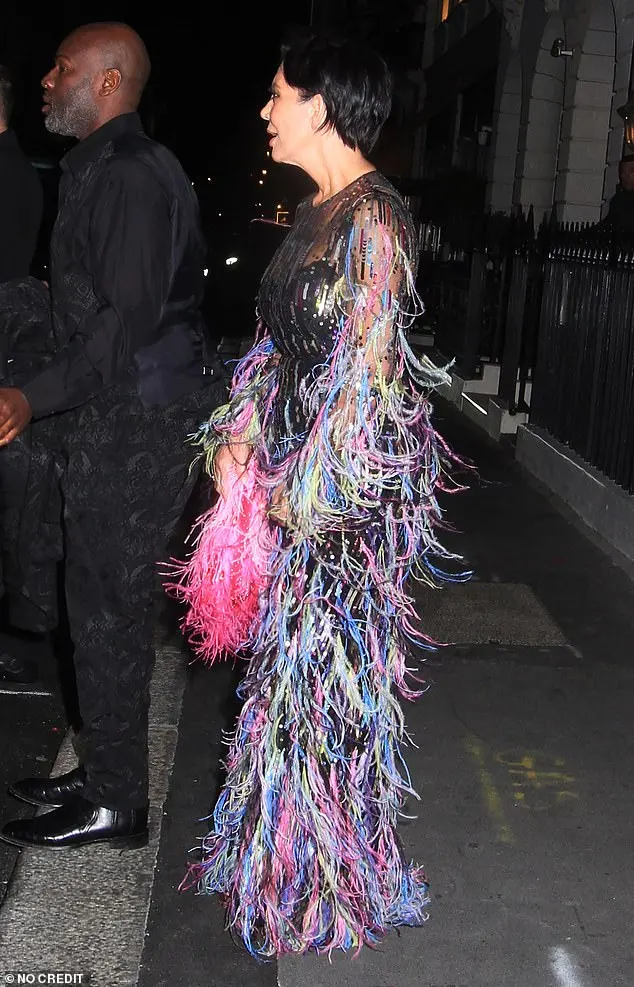 Her dress was covered in feathers and lines of sequins in all different colours, and she accesorised with a fluffy pink purse