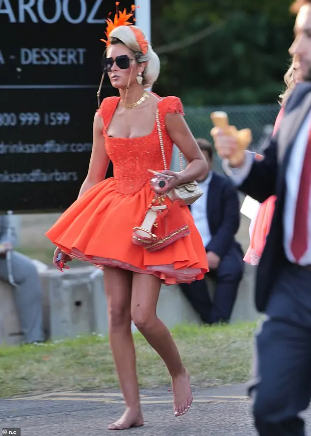 Elsewhere another racegoer was spotted in a stunning bright orange ensemble , which she paired with a matching fascinator