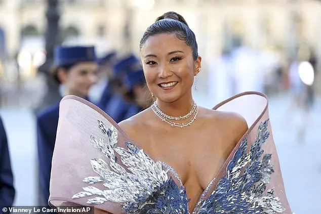 Scraping her brunette locks back into a curled ponytail, Ashley completed the look with some final touches of sparkle from her array of necklaces and dangly diamond earrings