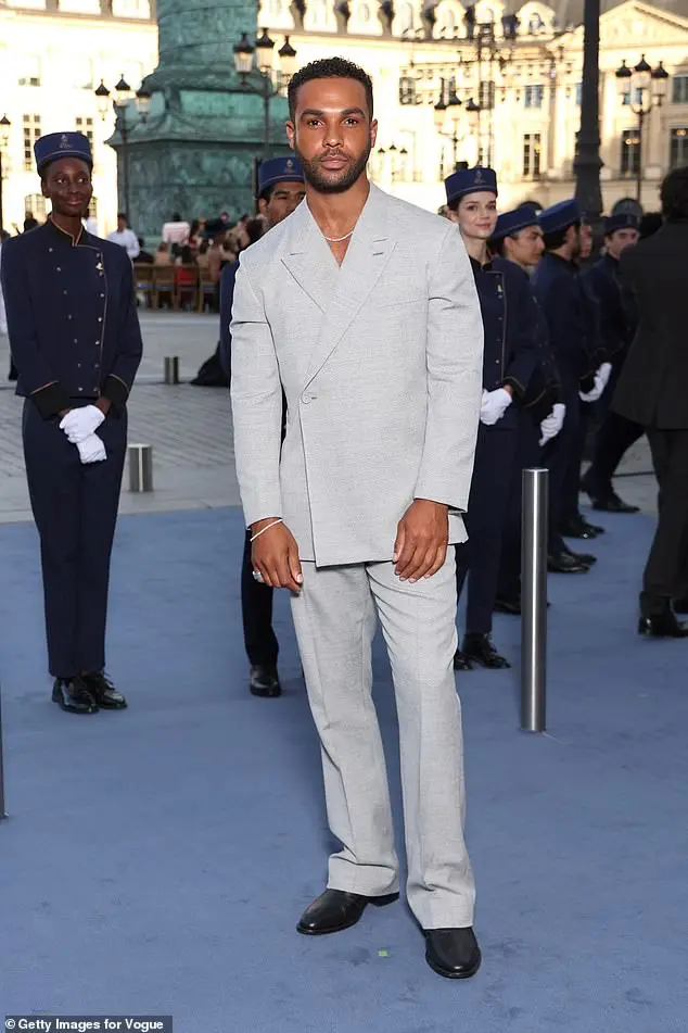 Ashley was joined by her Emily In Paris co-star Lucien Laviscount who cut a dapper figure in a simple light grey suit and black shoes