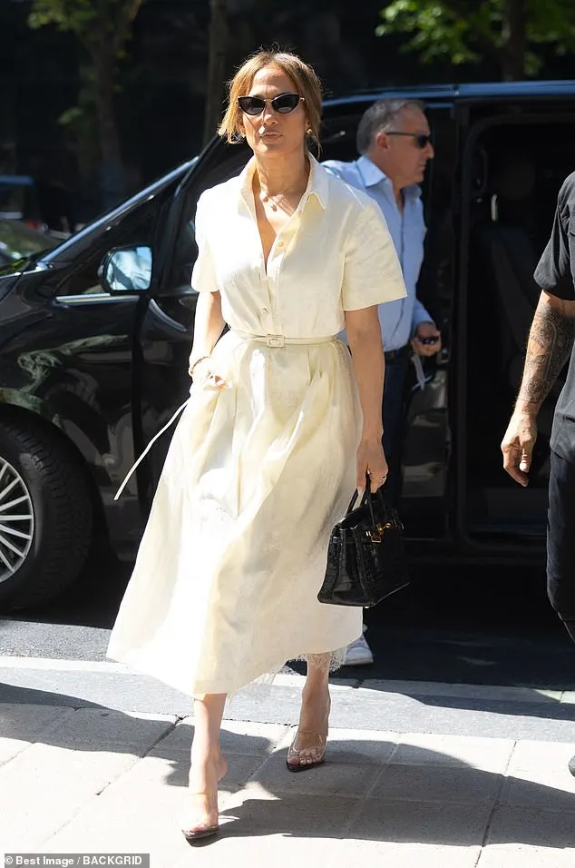 The singer, 54, embraced the warm summer weather as she slipped into a light yellow short-sleeved midi dress