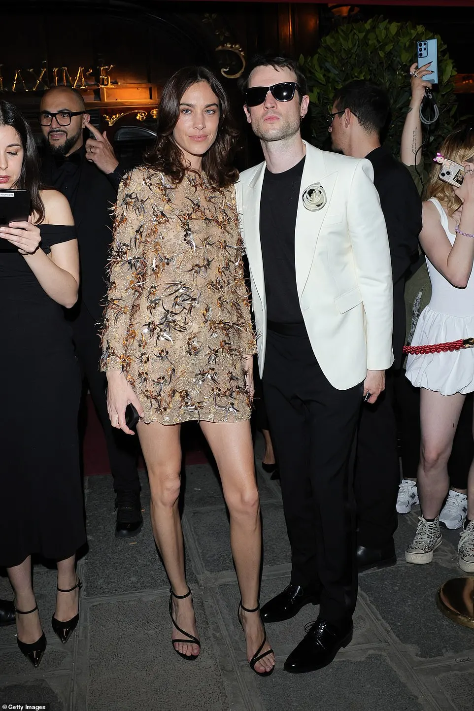 Alexa Chung changed into a sparkly mini dress as she sweetly posed with her rumoured fiancé Tom Sturridge