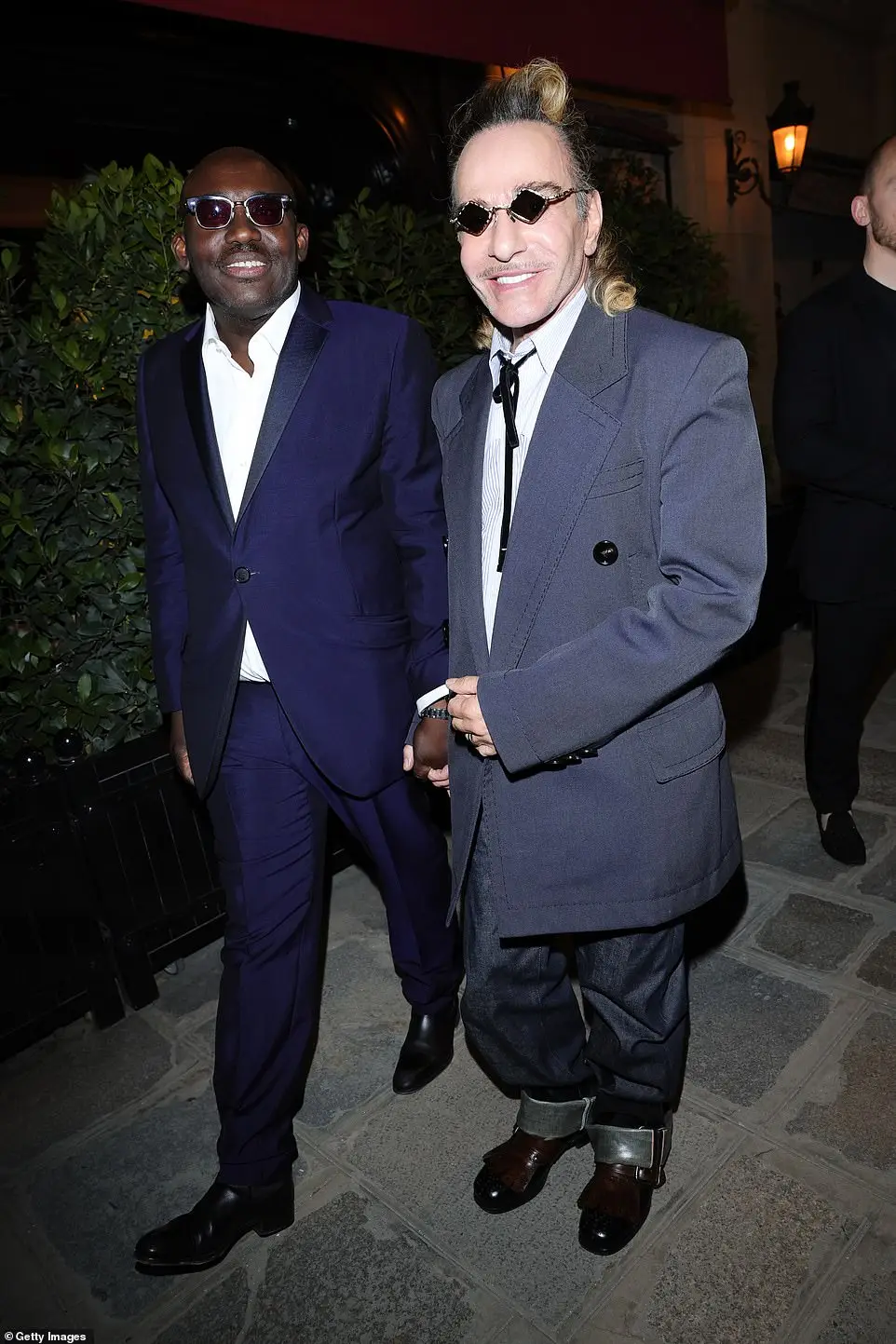 John Galliano and Edward Enninful held hands as they walked into the venue to celebrate the success of Vogue World's Paris event