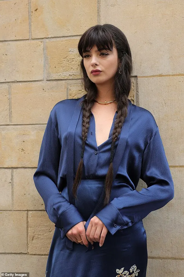 The 19-year-old posed for photos in an eye-catching blue satin dress, which included gold embellished details depicting birds and flowers