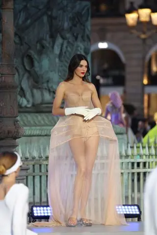 Kendall Jenner walks in the Vogue World fashion show wearing a sheer corset gown