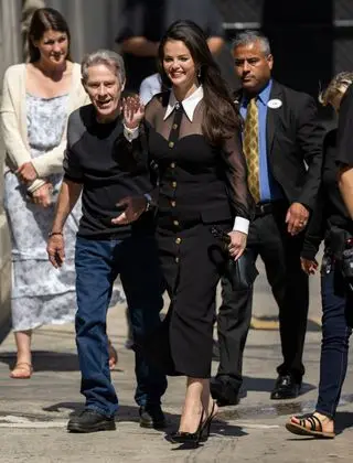 Selena Gomez entering jimmy kimmel live with a black dumpling bag