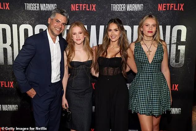 The mom-of-three posed alongside her girls and husband Cash Warren while on the Netflix movie's premiere carpet