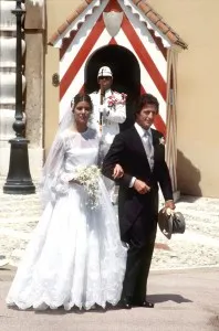 Princess Caroline and Philippe Junot walk through the flag-bedecked streets of old Monaco after their June 29 civil wedding service.