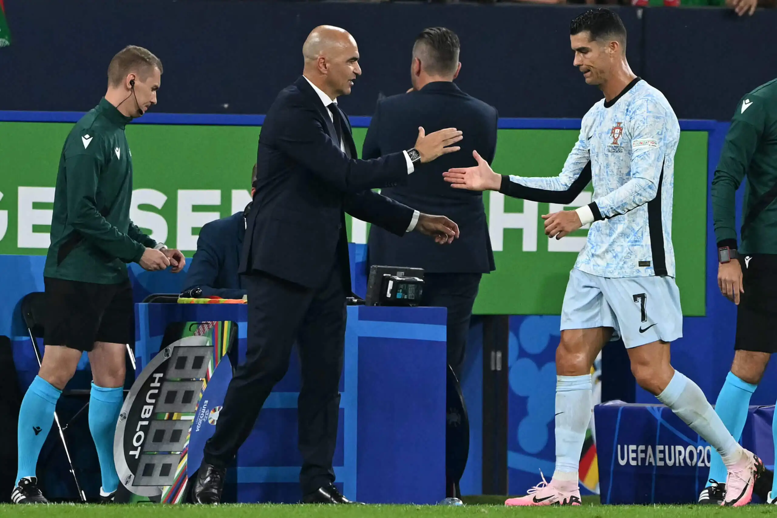 Roberto Martinez shakes hands with Cristiano Ronaldo