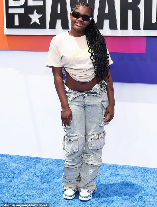 Jaylynn Jones was stylishly casual in a white, cropped shirt as well as a pair of low-waisted, denim pants