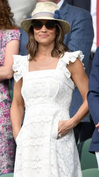 Pippa Middleton at day four Wimbledon 2018 wearing a white dress and hat with blue pompoms on