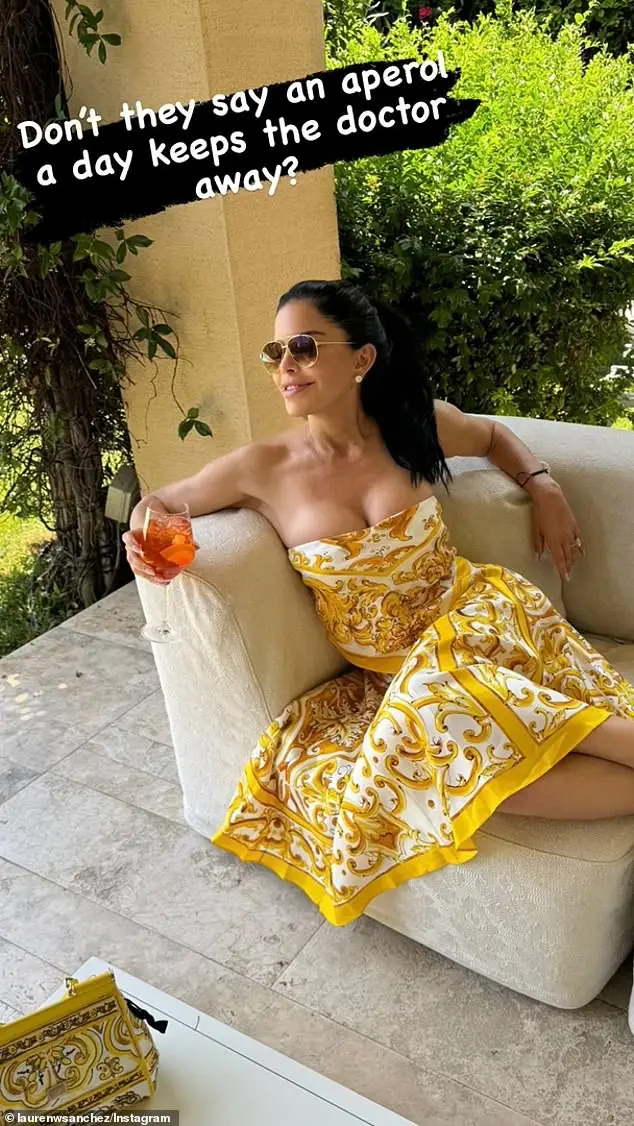 Jeff Bezos' fiancee Lauren Sanchez (pictured) sipped on an Aperol spritz while wearing a Dolce & Gabbana dress in a new photo shared to social media on Tuesday