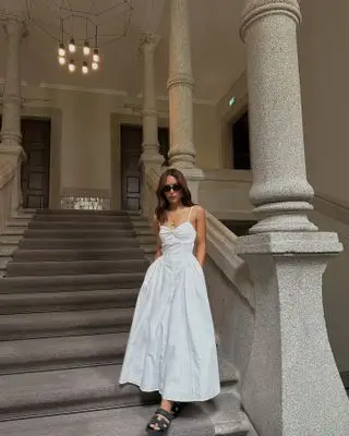 Woman wearing white maxi dress.