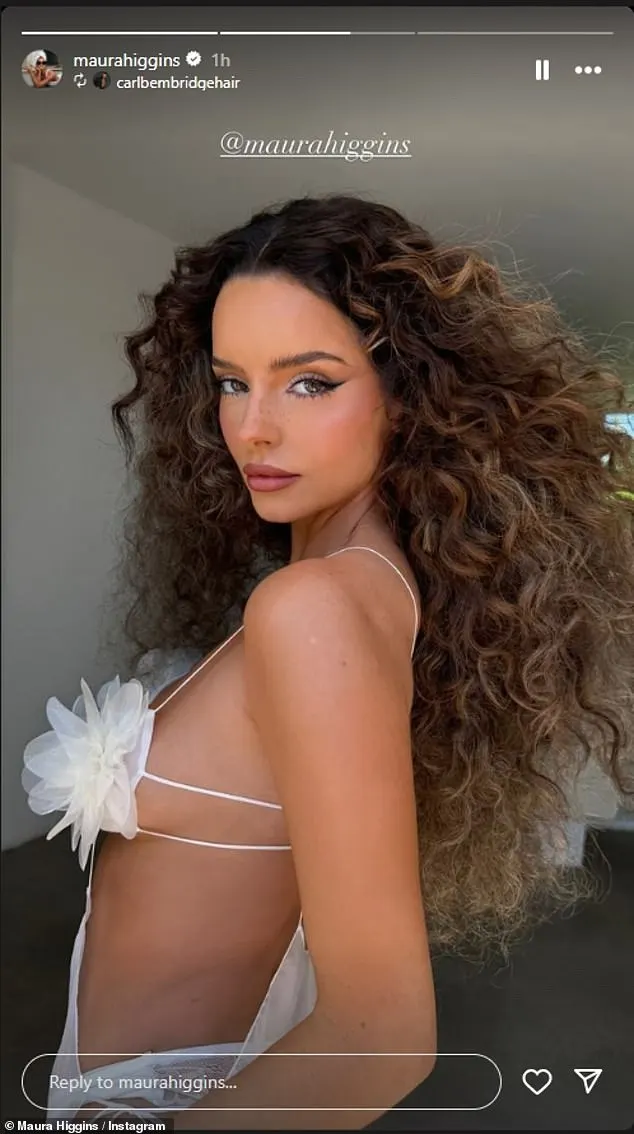 Maura Higgins sent temperatures soaring on Tuesday as she put on a busty display in a racy sheer white dress and showed off her curly locks