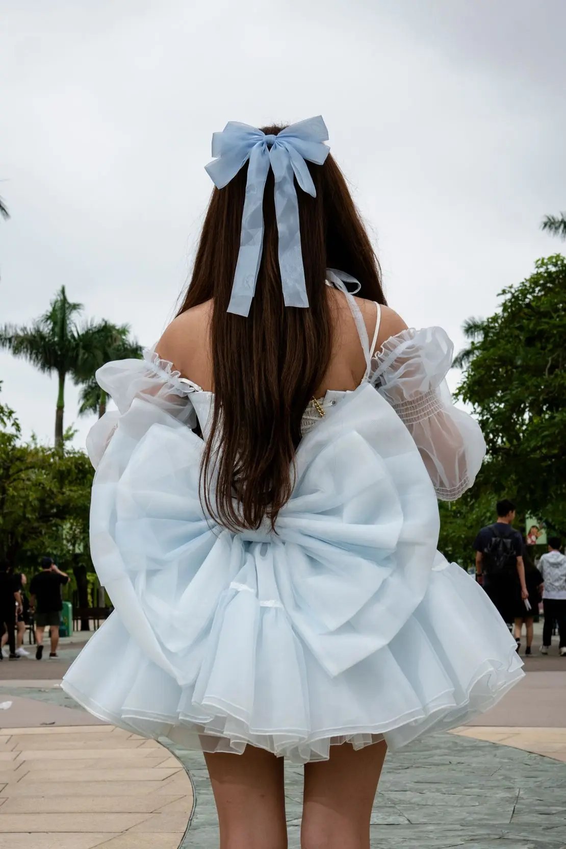 A giant bow adorns the back of her minidress.