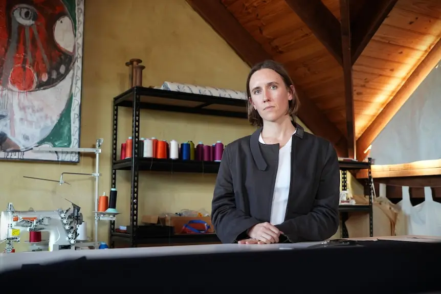 A woman named Luka Rey stands in a fashion design studio.