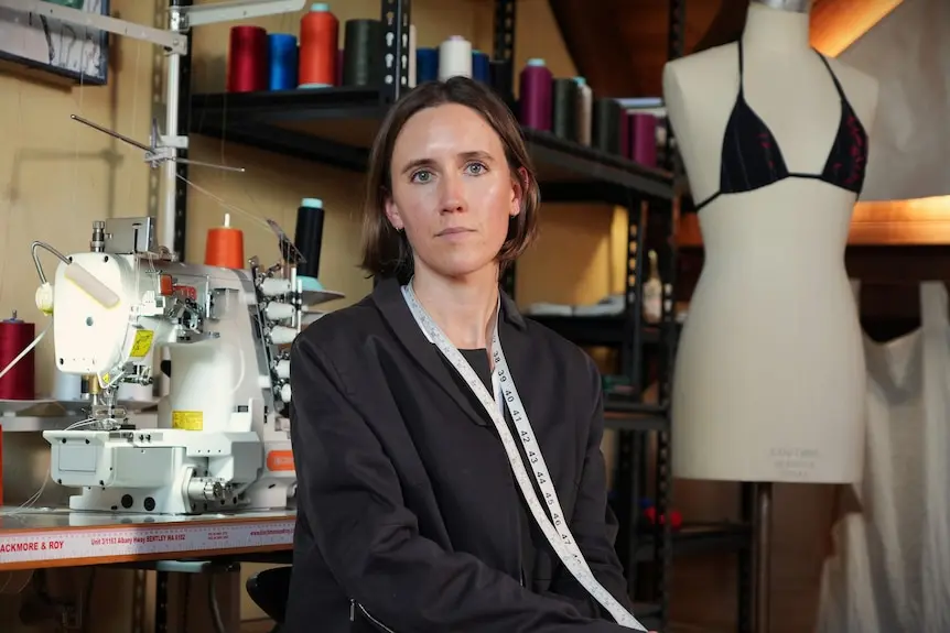 A woman named Luka Rey stands in a fashion design studio.