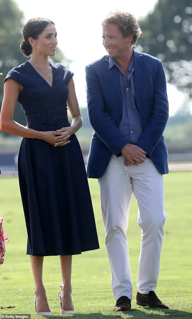 Duchess of Sussex stands with former Sentebale Chairman Johnny Hornby (who is married to ME+EM founder Clare Hornby) during the Sentebale Polo 2018