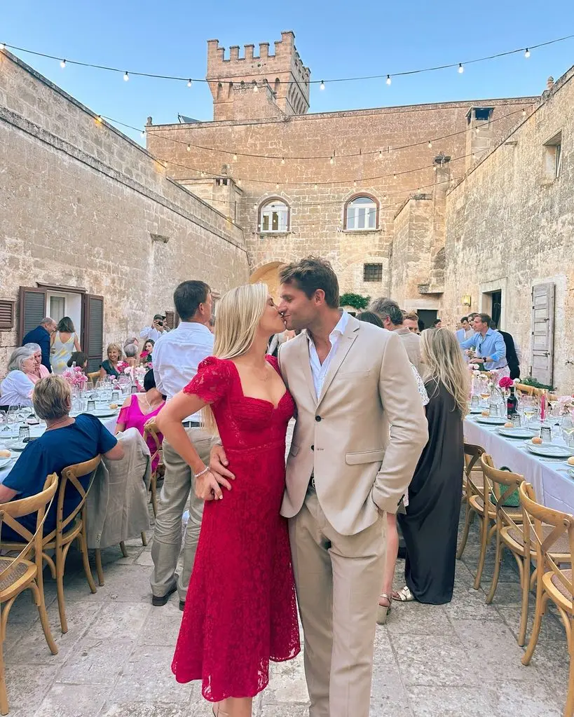 Amelia Spencer kissing husband Greg Mallett at Italian wedding