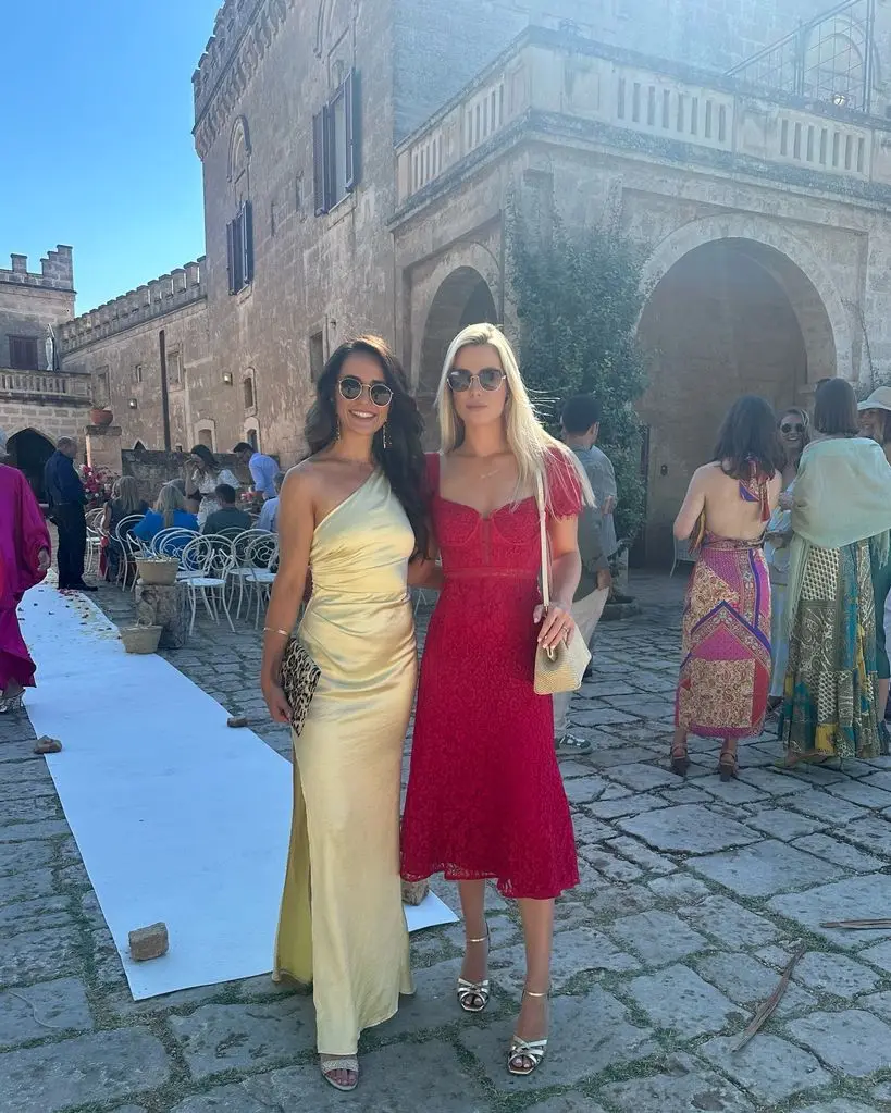 Amelia Spencer in red Self-Portrait dress with wedding guest