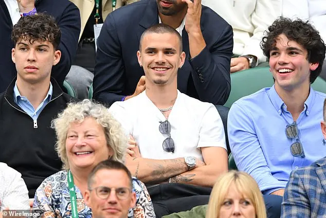 21-year-old Romeo stuck out in a casual t-shirt next to his friends who dressed in smart navy shirts