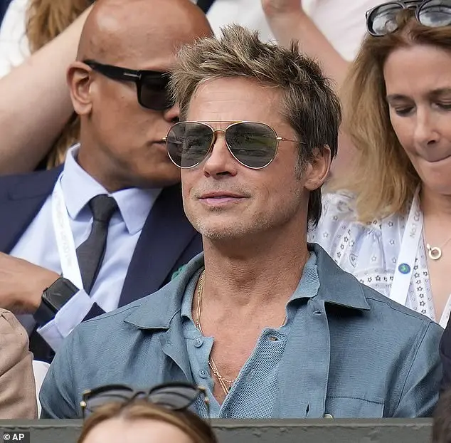 Brad Pitt cut a smart figure at the tennis event in 2023, opting for a knitted blue polo shirt and matching blazer jacket