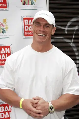 Image may contain John Cena Clothing TShirt Baseball Cap Cap Hat Accessories Bracelet Jewelry Wristwatch and Face