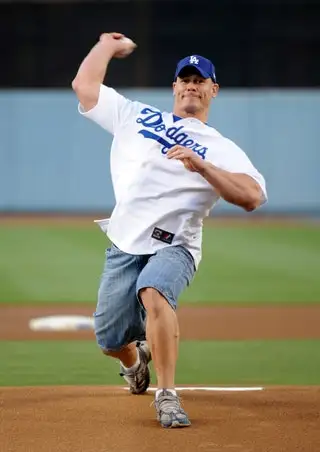 Image may contain John Cena Person Throwing Ball Baseball Baseball Sport Baseball Cap Cap Clothing and Hat