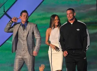 Image may contain John Cena Maggie Q Blazer Clothing Coat Jacket Formal Wear Suit Accessories Tie and People